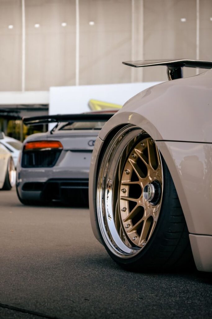 A close-up shot of luxury sports cars in Wrocław, showcasing elegant wheel design.